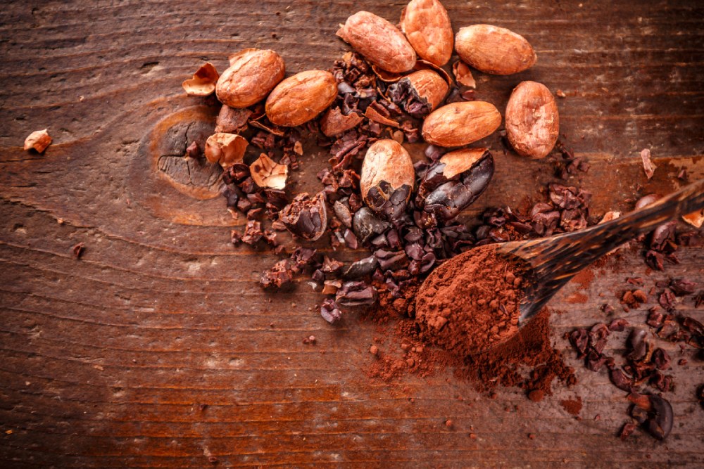 A vibrant bowl of Coracao Confections cacao nibs, rich in antioxidants and healthy fats, ready to be sprinkled on oatmeal, smoothies, or enjoyed straight as a nutritious snack.